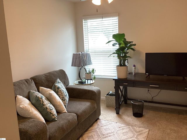 interior space with carpet floors and ceiling fan