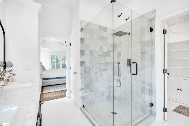 bathroom with ornamental molding, sink, and an enclosed shower