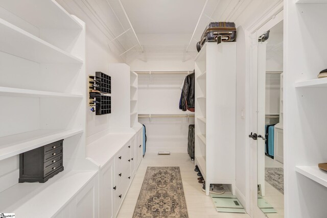 bedroom featuring crown molding, ceiling fan, and light colored carpet