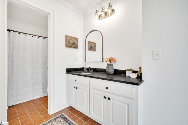 bathroom with ornamental molding, tile patterned floors, and vanity