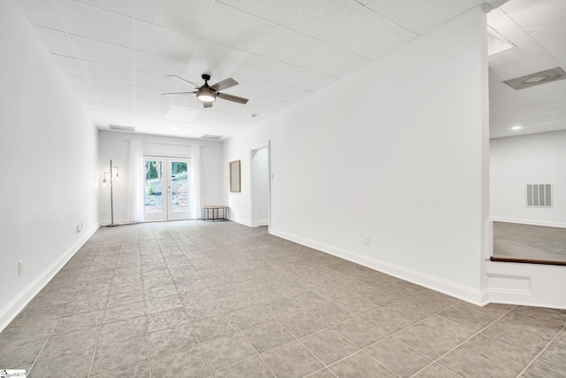 tiled spare room with french doors and ceiling fan