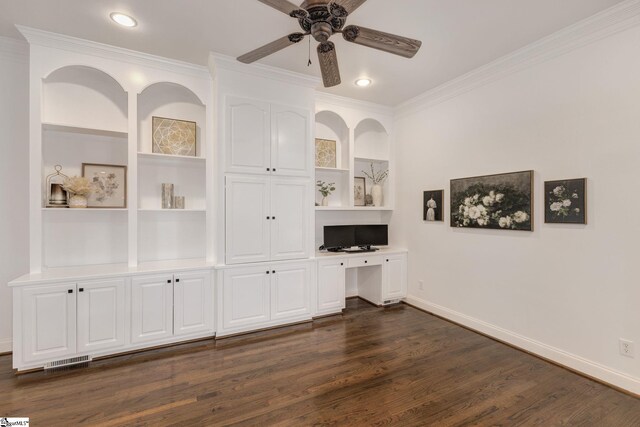 unfurnished office featuring built in shelves, crown molding, and built in desk