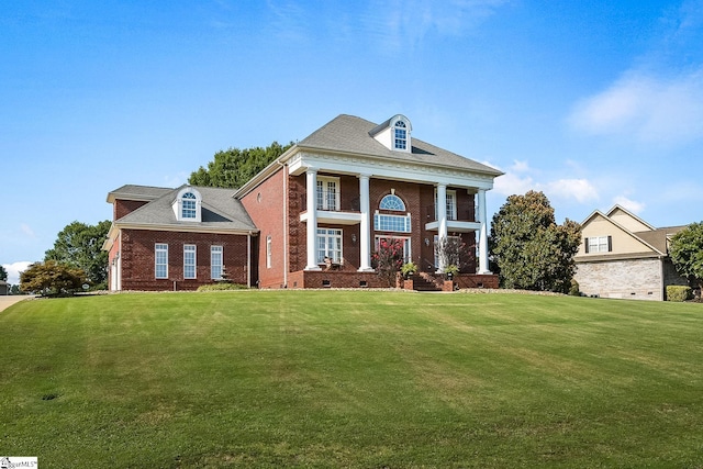 greek revival house featuring a front yard