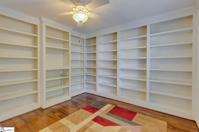 walk in closet with hardwood / wood-style floors and ceiling fan