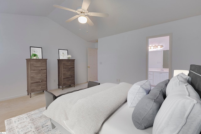 bedroom featuring light carpet, vaulted ceiling, connected bathroom, and ceiling fan