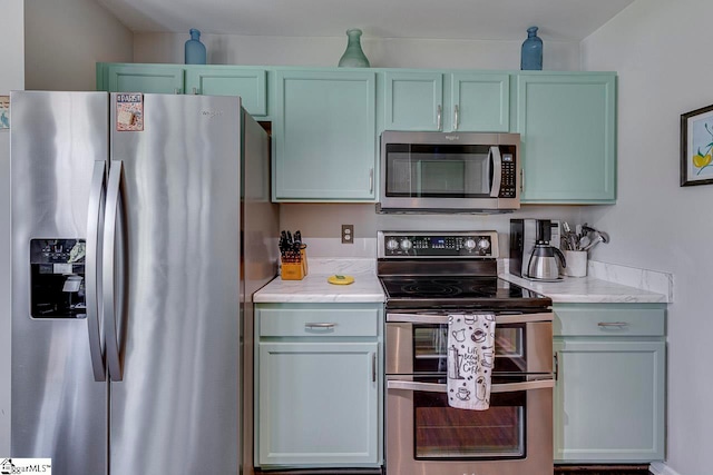 kitchen featuring appliances with stainless steel finishes and light stone countertops