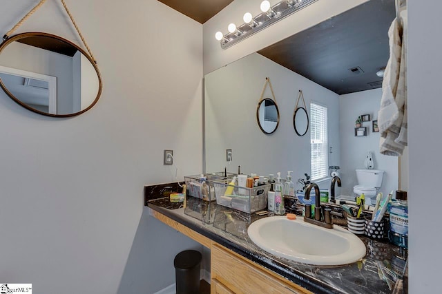 bathroom with vanity and toilet