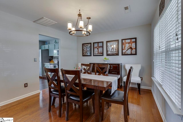 dining area featuring a chandelier and hardwood / wood-style floors