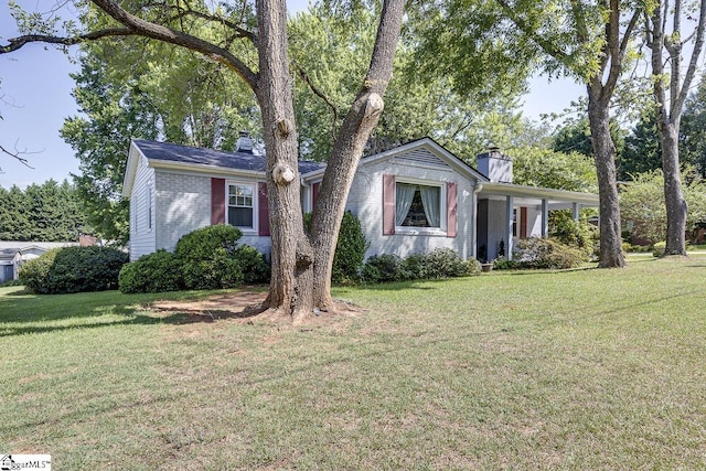 ranch-style home with a front lawn