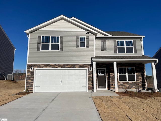 view of front of property featuring a garage, a porch, and central AC