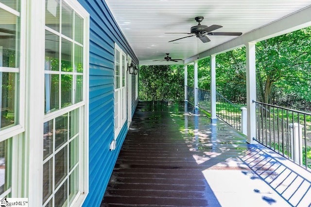 wooden terrace featuring ceiling fan and a porch