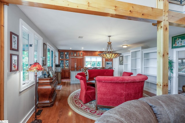 living room featuring recessed lighting, visible vents, baseboards, and wood finished floors