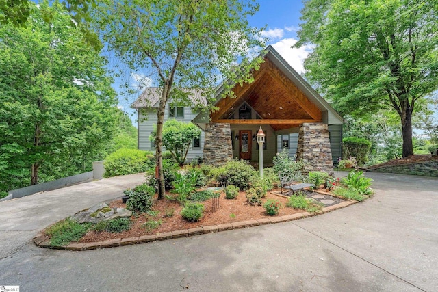 view of front of property with stone siding and concrete driveway