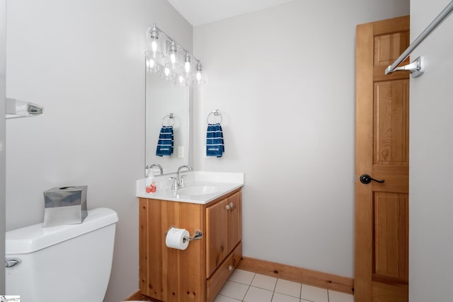 bathroom featuring baseboards, vanity, toilet, and tile patterned floors