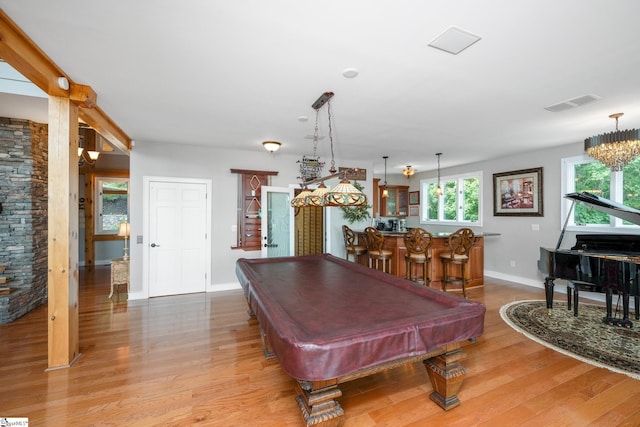 playroom featuring wood-type flooring, a notable chandelier, and pool table