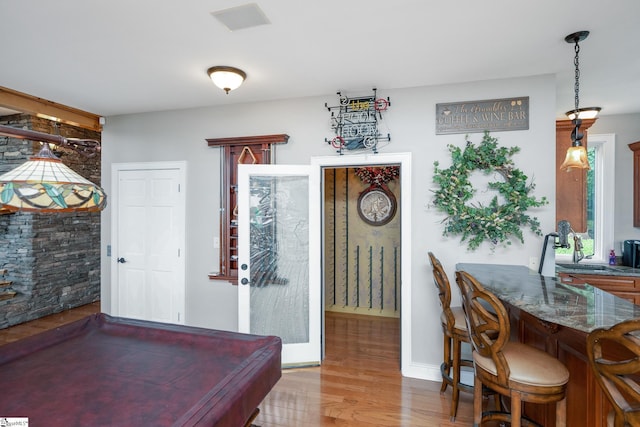 game room featuring a sink and wood finished floors