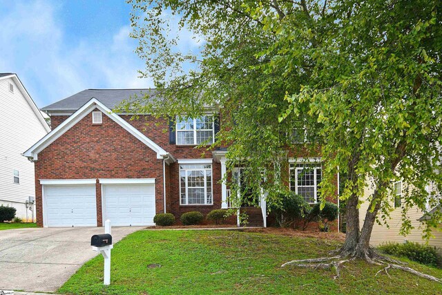 view of front of property featuring a garage and a front yard