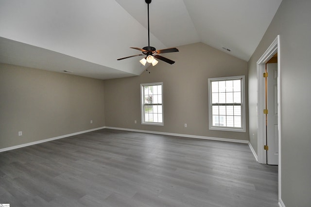 spare room with hardwood / wood-style flooring, ceiling fan, and lofted ceiling