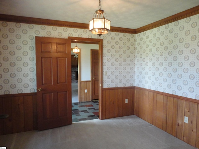 spare room featuring wooden walls and carpet