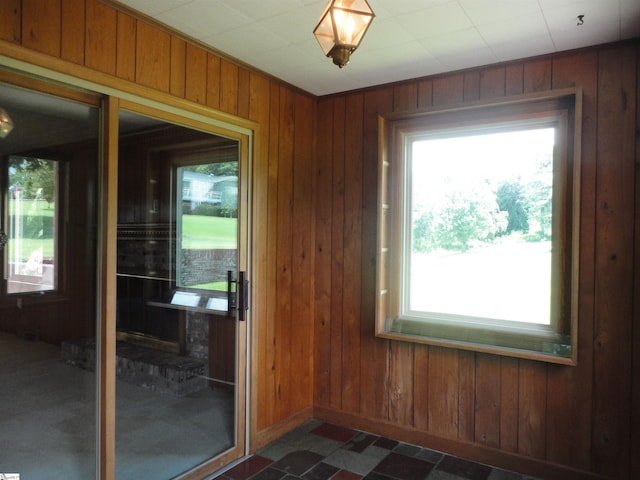 doorway to outside featuring wooden walls