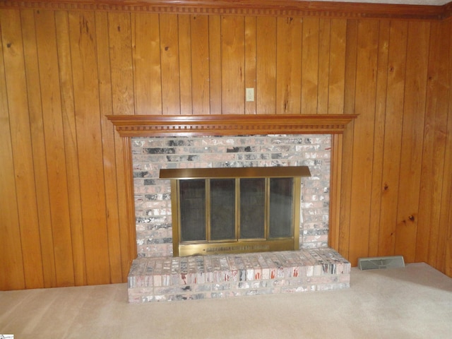 details featuring wooden walls, a fireplace, and carpet flooring