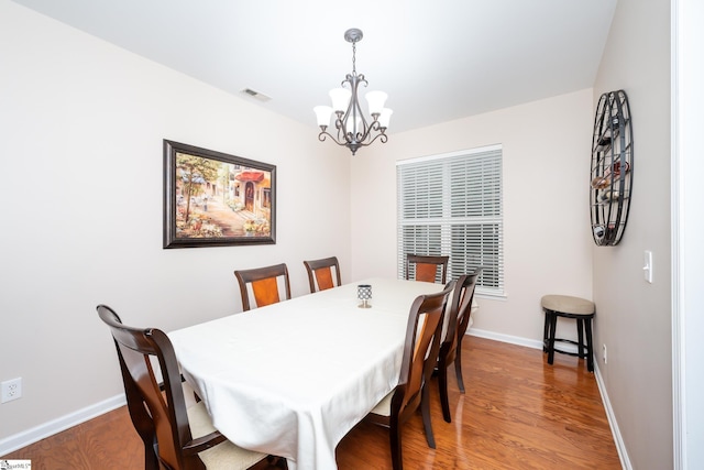 dining room featuring an inviting chandelier and hardwood / wood-style flooring