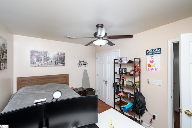 bedroom featuring wood-type flooring, a closet, and ceiling fan