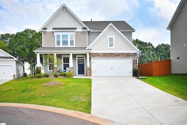 craftsman-style home with a garage, a front yard, and covered porch