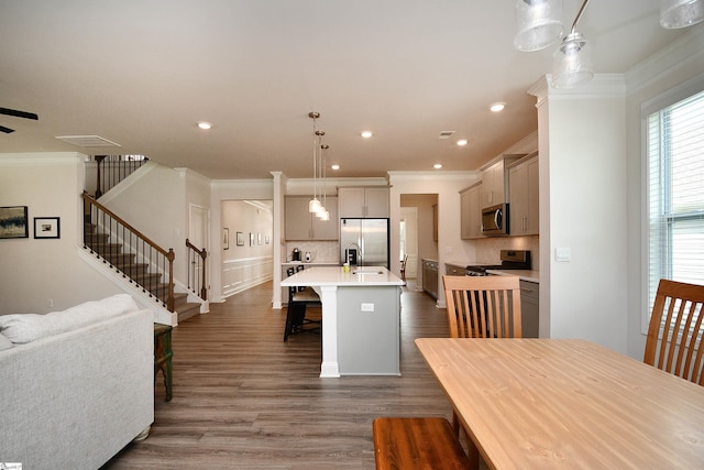 dining room featuring stairway, ornamental molding, wood finished floors, and recessed lighting