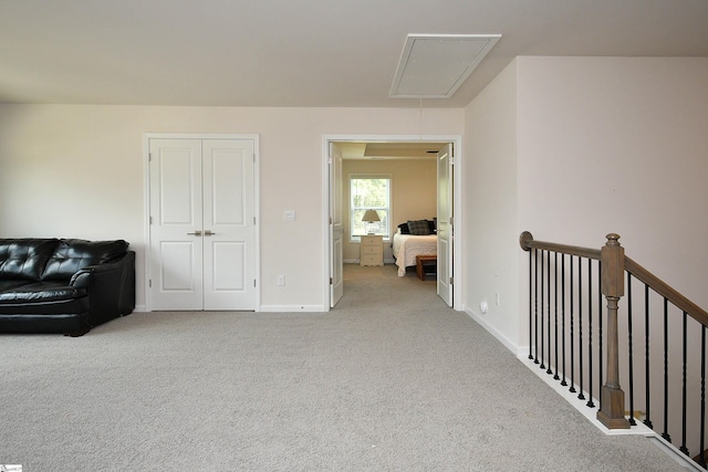 hall featuring light colored carpet