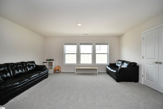 living room featuring carpet and baseboards