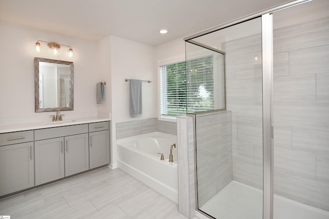 bathroom with shower with separate bathtub, tile patterned floors, and vanity