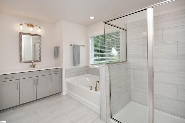 bathroom with a garden tub, vanity, recessed lighting, and a shower stall
