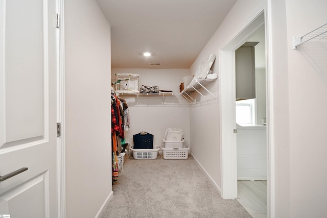 walk in closet featuring visible vents and carpet floors