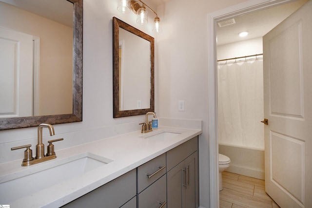 full bathroom featuring tile patterned flooring, double sink vanity, toilet, and shower / tub combo with curtain