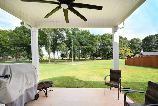 view of patio / terrace featuring an outdoor fire pit, area for grilling, ceiling fan, and fence