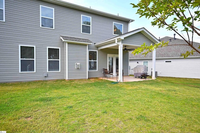 rear view of property featuring a patio area and a yard