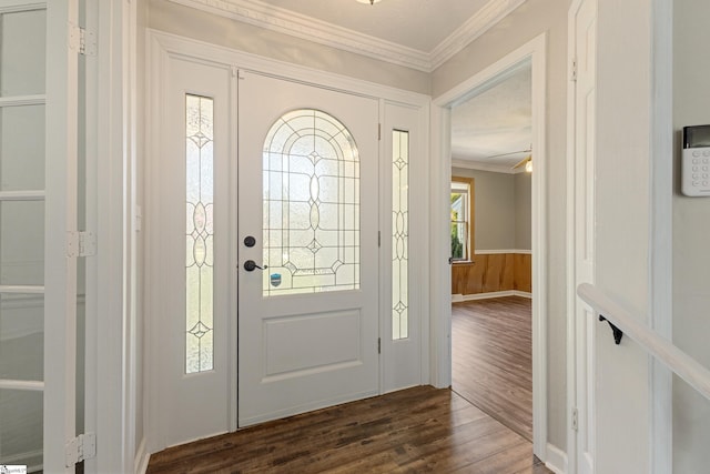 foyer entrance featuring dark wood-type flooring and ornamental molding