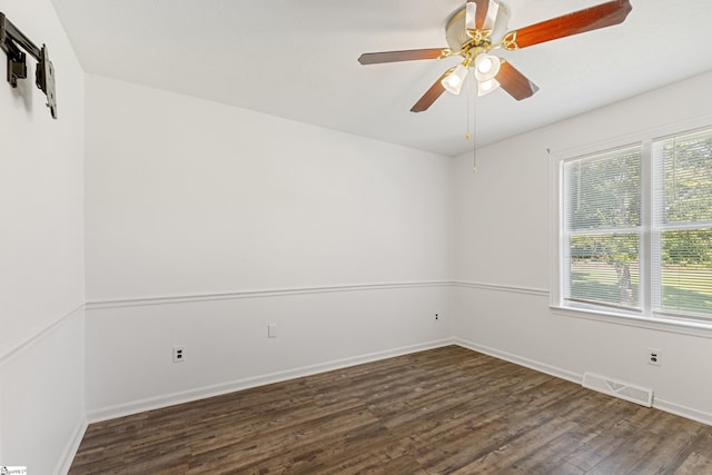 empty room with dark hardwood / wood-style flooring, plenty of natural light, and ceiling fan