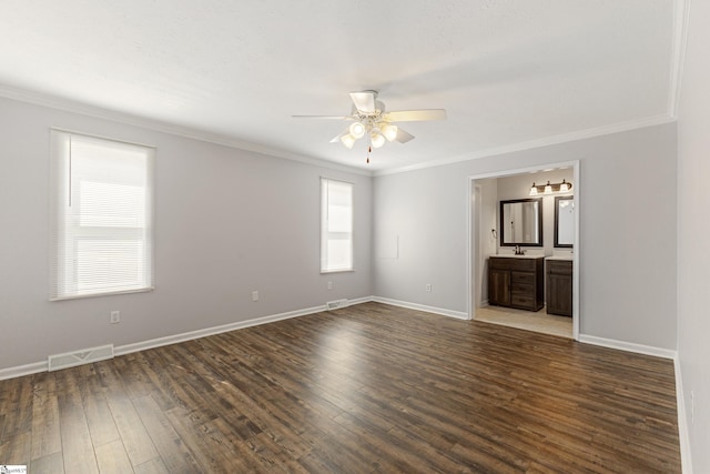 empty room with dark hardwood / wood-style flooring, sink, ornamental molding, and ceiling fan