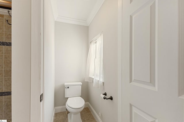 bathroom featuring tile patterned flooring, ornamental molding, and toilet