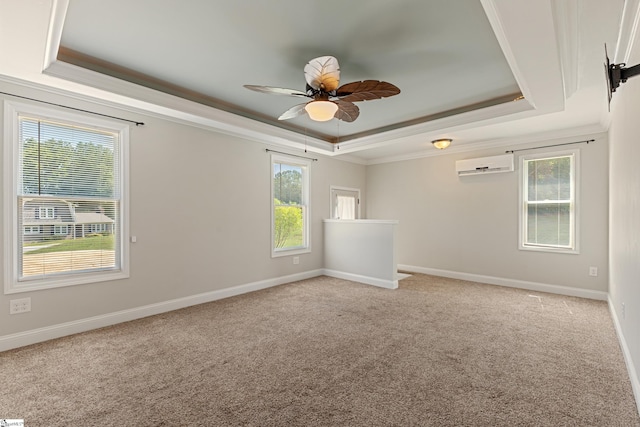 carpeted spare room featuring crown molding, a wall mounted AC, a raised ceiling, and ceiling fan