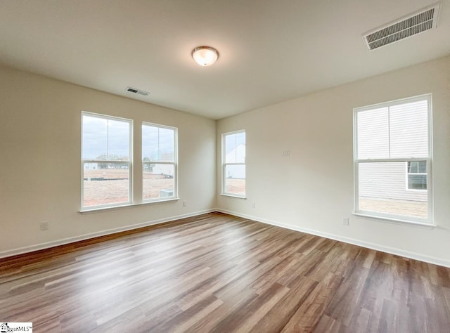 spare room with light hardwood / wood-style floors