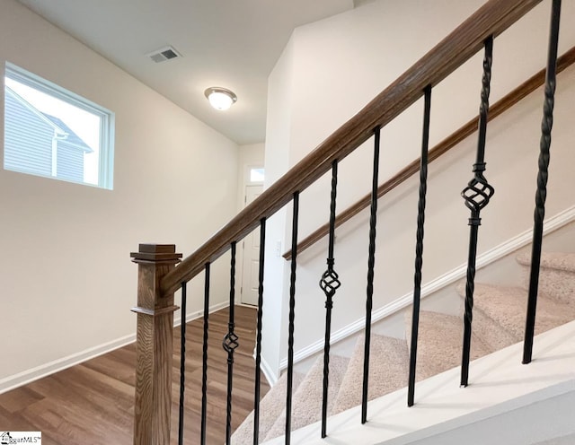 stairs with wood-type flooring