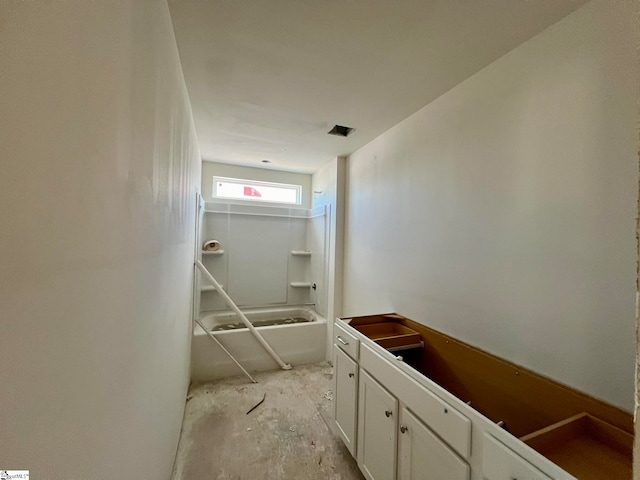 bathroom featuring bathing tub / shower combination, vanity, and concrete floors