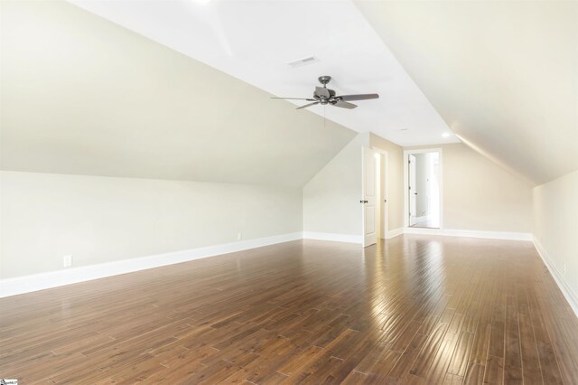 additional living space with vaulted ceiling, ceiling fan, and dark hardwood / wood-style flooring