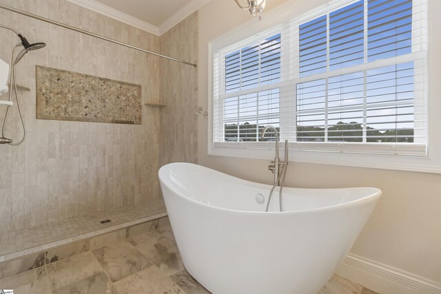 bathroom with plenty of natural light, ornamental molding, and shower with separate bathtub