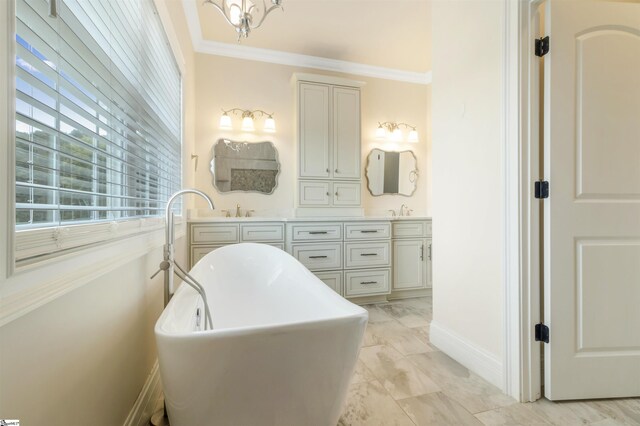 bathroom with vanity, crown molding, and a bathing tub