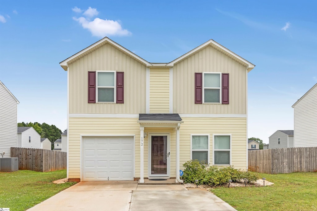 view of front of home featuring a front lawn, cooling unit, and a garage