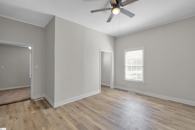 empty room with light hardwood / wood-style floors and ceiling fan